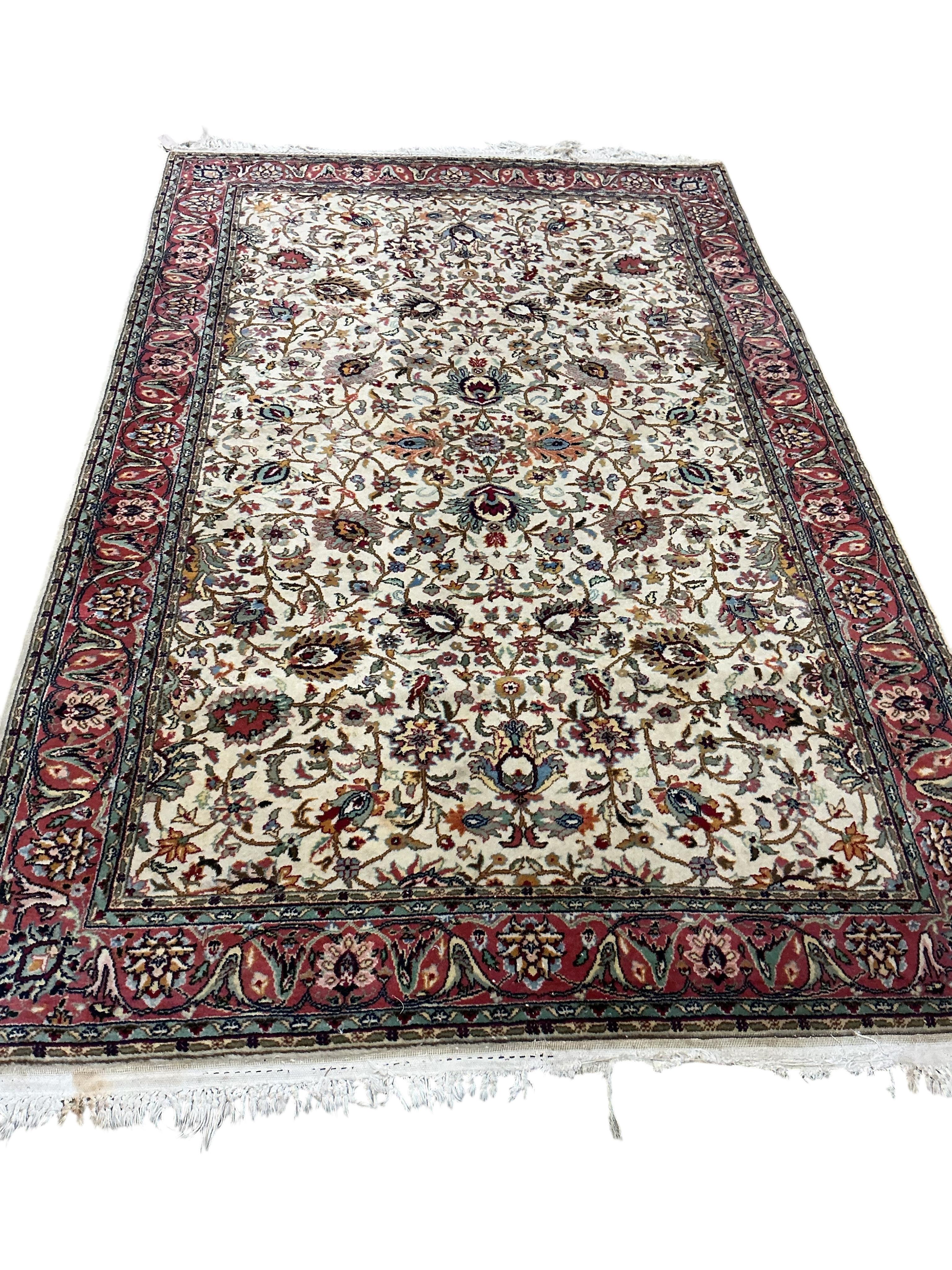 A Tabriz ivory ground carpet, 230 x 146cm